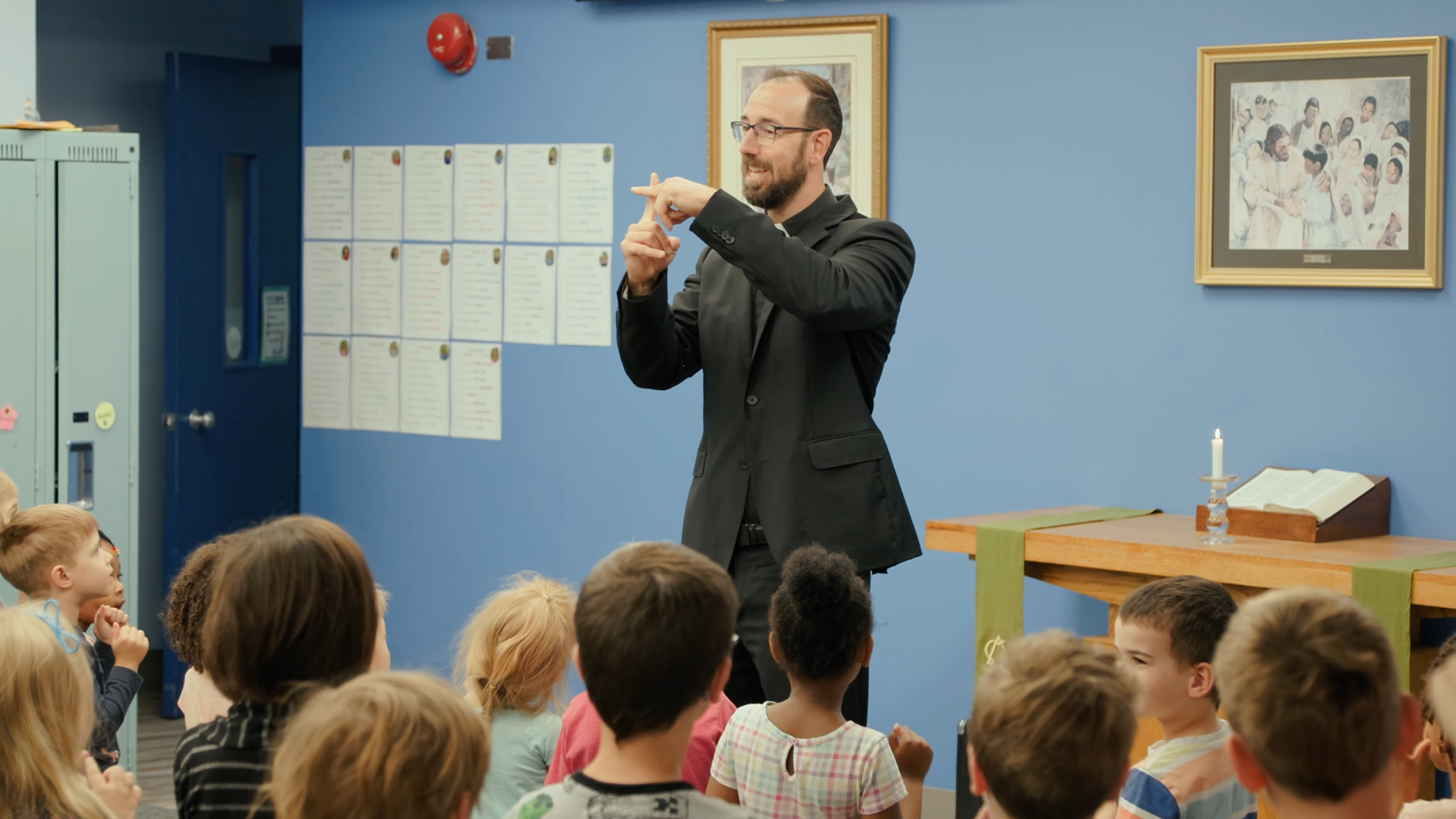 Pastor at chapel service with elementary students.