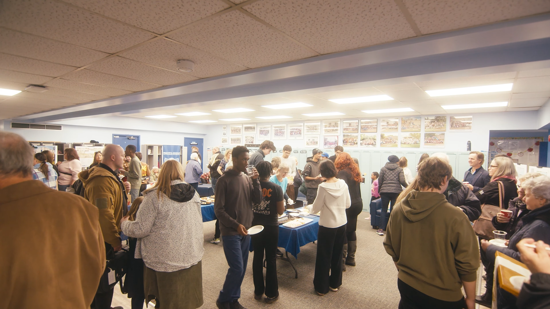 People inside a school for refreshments after an event.
