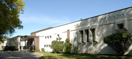 Front of Beautiful Saviour Lutheran School on a nice day, with nature in front.